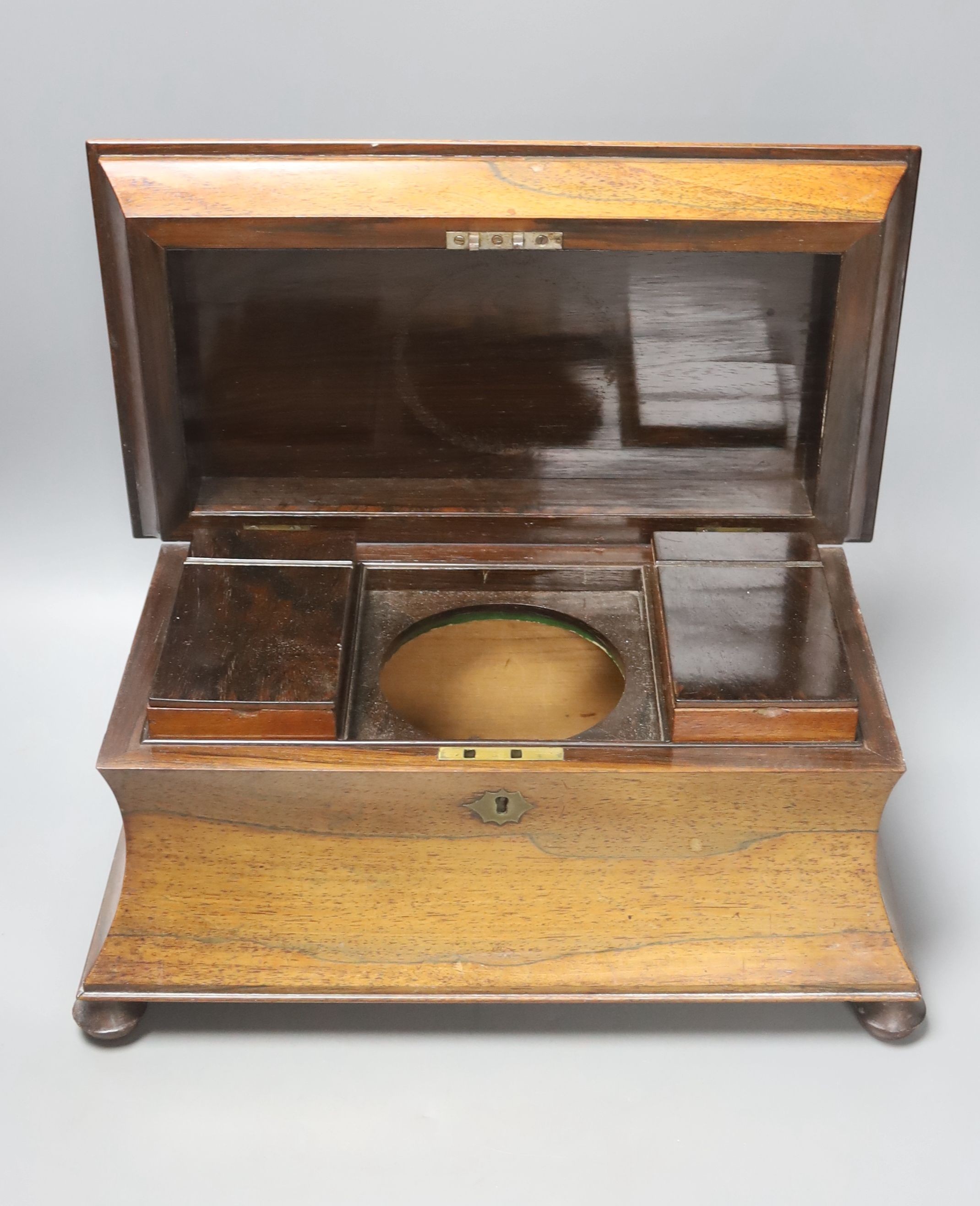 A Victorian rosewood sarcophagus tea caddy, 36.5 cm, a mahogany caddy and a Victorian Walnut and brass mounted casket